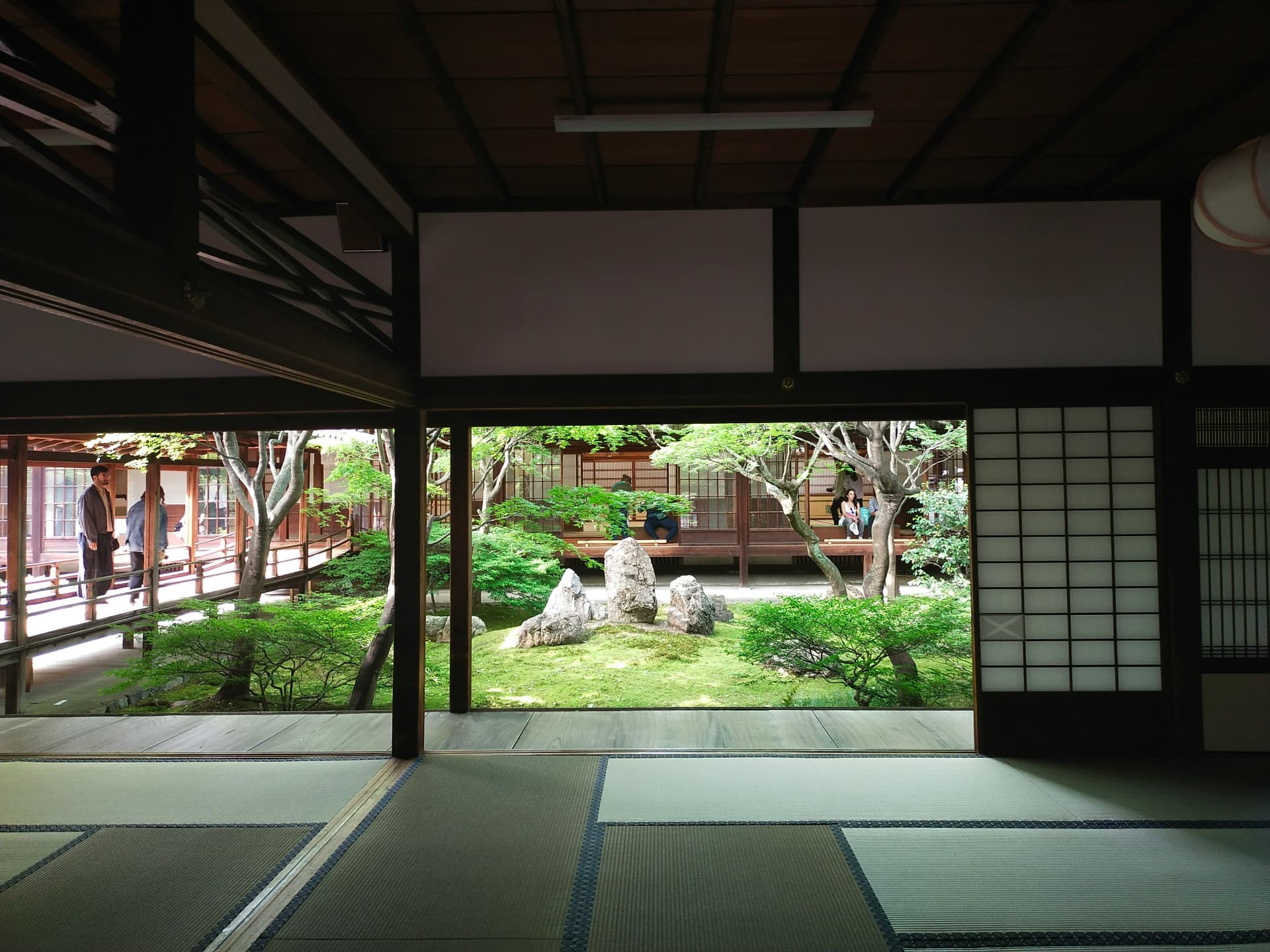 Tatami room opening onto a moss and stone garden